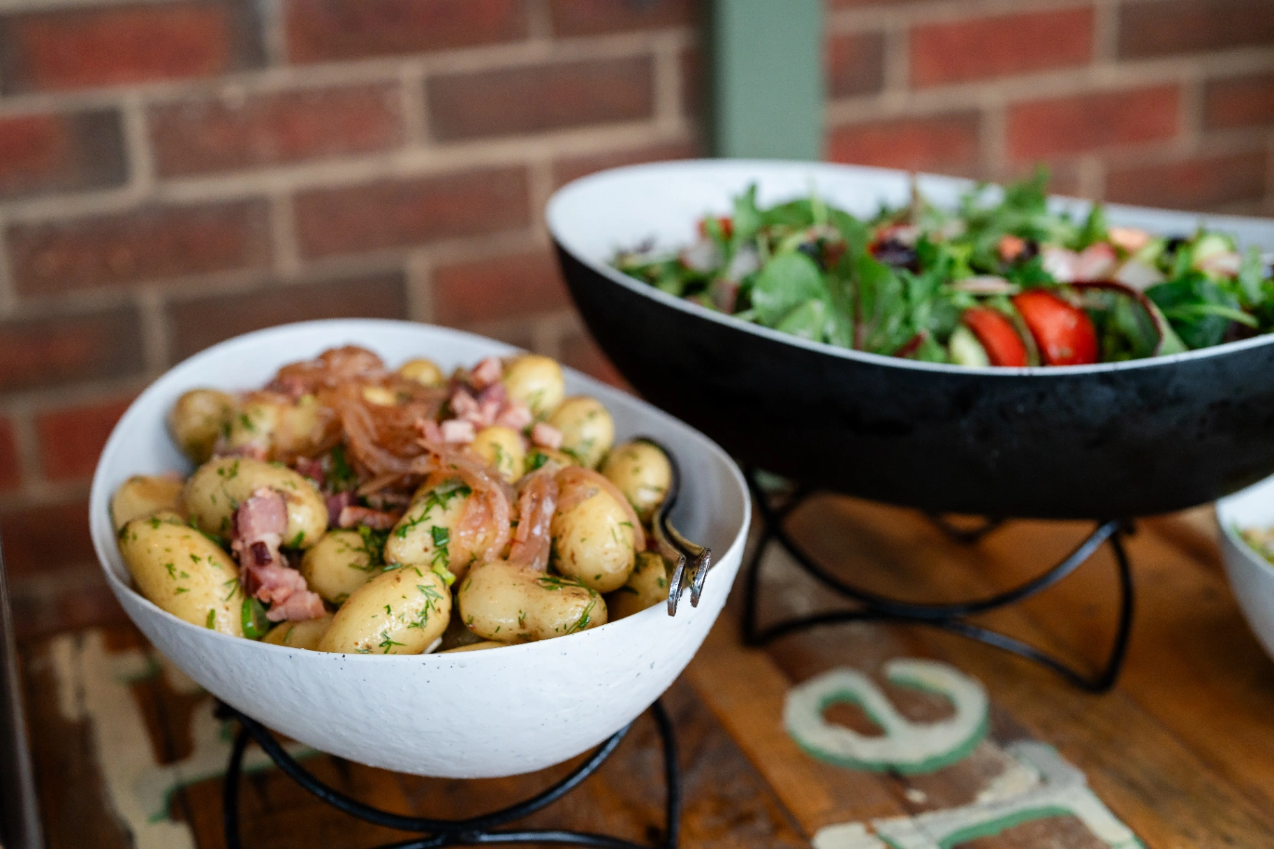 Catering buffet spread with fresh garden salad and dill potato sides
